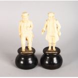 A PAIR OF EUROPEAN CARVED IVORY FIGURES OF MR PICKWICK and CAPT. CUTTLE. 3.5ins high, on turned