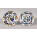 A PAIR OF POLYCHROME DUTCH DELFT PLATES, LATE 18TH CENTURY, decorated with flowers and vases with