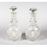 A GOOD PAIR OF HOBNAIL CUT DECANTERS AND STOPPERS.