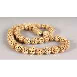 A PIERCED IVORY SPHERES NECKLACE.