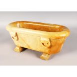 A RARE ITALIAN SIENNA MARBLE MINIATURE BATH of plain design, with ring handles on two plank bases.