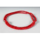 A LONG RED JADE SINGLE ROW NECKLACE.