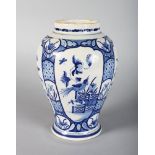 A DELFT BLUE AND WHITE VASE decorated with panels of flowers. 10ins high.