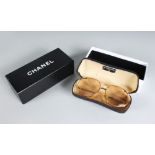 A PAIR OF CHANEL SUNGLASSES, in a Chanel box.