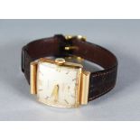 A 14K GOLD LONGINES WRISTWATCH with leather strap.