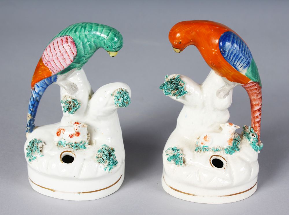 A PAIR OF STAFFORDSHIRE PEN HOLDERS, as colourful birds on a tree stump, with a tiny lamb. 5ins