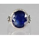 A 14K WHITE GOLD AND DIAMOND RING SET WITH AN OVAL CUT BLUE SAPPHIRE, approx. 8.10ct, diamonds