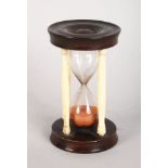 AN IVORY AND WOODEN EGG TIMER. 3.25ins high.