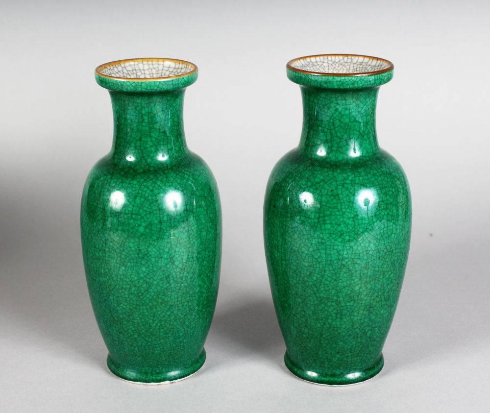 A PAIR OF GREEN CRACKLE GLAZE VASES. 8ins high.