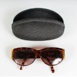 A PAIR OF PERCY SUNGLASSES, in a folding case.