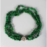 A SUPERB CARVED JADE THREE ROW NECKLACE with 18CT WHITE GOLD DIAMOND SET CLASP.