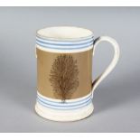 A QUART MOCHA TANKARD, decorated with two ferns. 6ins high.