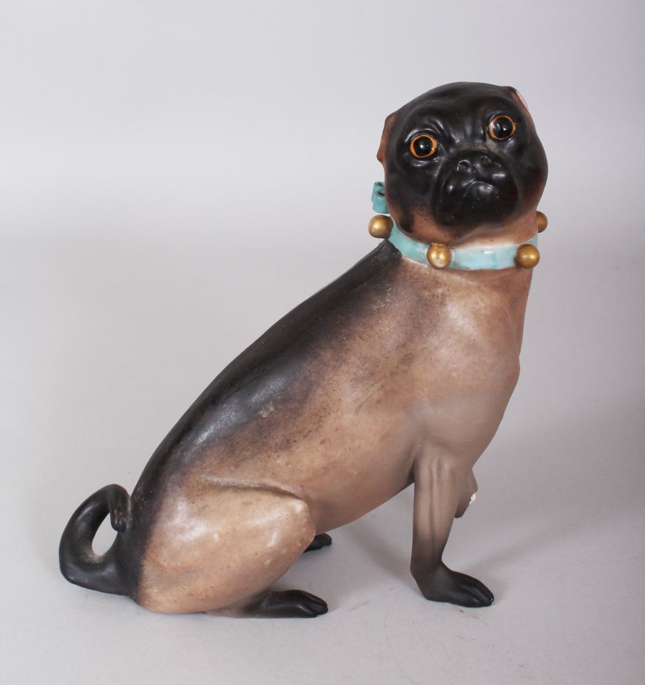 A MEISSEN SEATED PUG DOG with collar and glass eyes. Cross swords mark in blue. 6ins high.