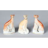 A SMALL PAIR OF STAFFORDSHIRE SEATED WHIPPETS with dead rabbits, 3.75ins high, and ANOTHER with no