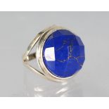 A SILVER AND LAPIS CUT RING.