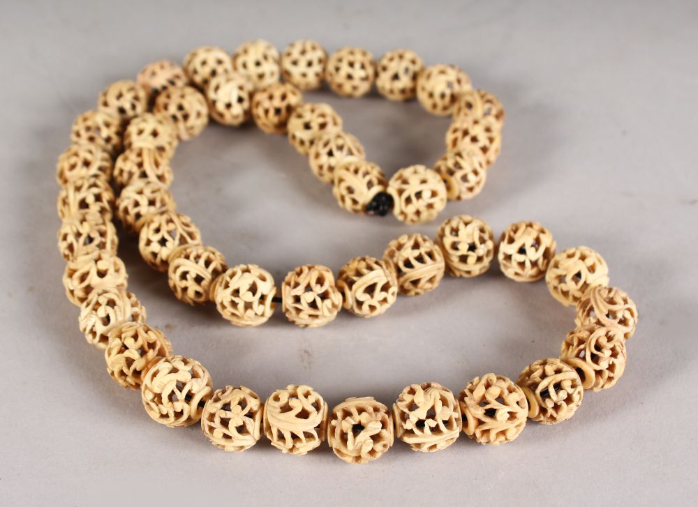 A PIERCED IVORY SPHERES NECKLACE. - Image 2 of 2