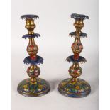 A PAIR OF PAINTED METAL CANDLESTICKS. 10.5ins high.