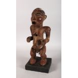 A CARVED WOOD FEMALE TRIBAL FIGURE. 15ins high.