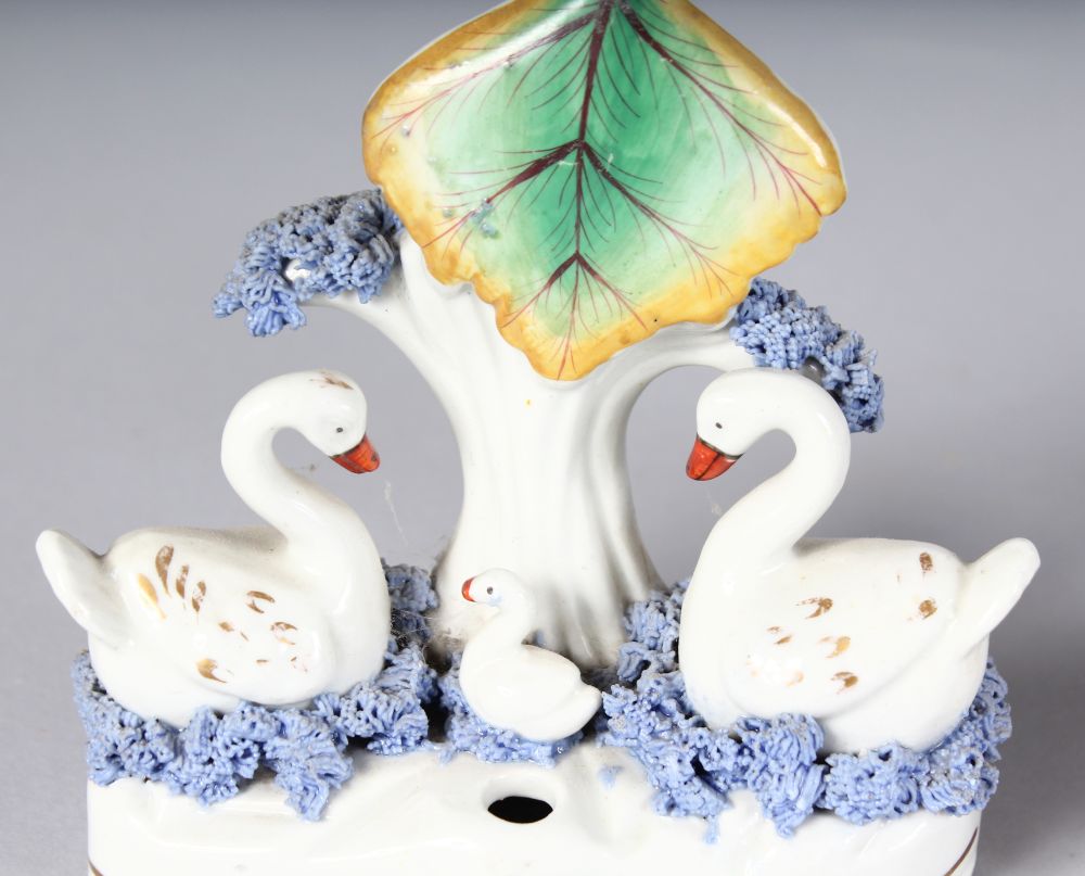 A STAFFORDSHIRE SWAN SPILL VASE with two swans and tree stump, on a shaped, encrusted base, 4. - Image 2 of 3