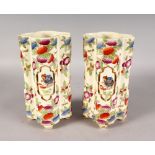 A PAIR OF CONTINENTAL QUATREFOIL CHINESE DESIGN VASES on turned bun feet. 10ins high.