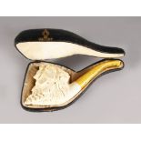 A GOOD MEERSCHAUM CARVED PIPE, head with fruiting vines in a leather case. 6.5ins long.