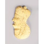 A GOOD SMALL EUROPEAN CARVED IVORY PLAQUE of a DOUBLE HEAD. 3ins long.