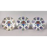 THREE POLYCHROME DUTCH DELFT PLATES, MID-LATE 18TH CENTURY, boldly painted in blue, iron-red,