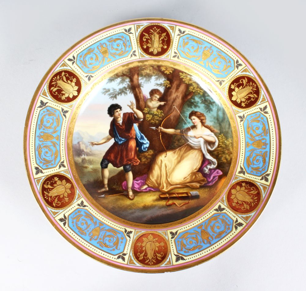 A VIENNA CIRCULAR PLATE, "Euryds Pastime", classical painted scene with gilt and enamel border.
