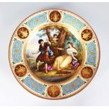 A VIENNA CIRCULAR PLATE, "Euryds Pastime", classical painted scene with gilt and enamel border.