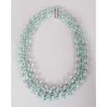 A WHITE GOLD THREE ROW FACETED AQUAMARINE NECKLACE.