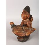 A 20TH CENTURY YORUBA TRIBAL CARVED WOODEN PAINTED FOOD BOWL AND COVER. 11ins high.