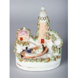 A STAFFORDSHIRE LIGHTHOUSE GROUP, lighthouse, cottage and figures in a boat. 6.5ins high.