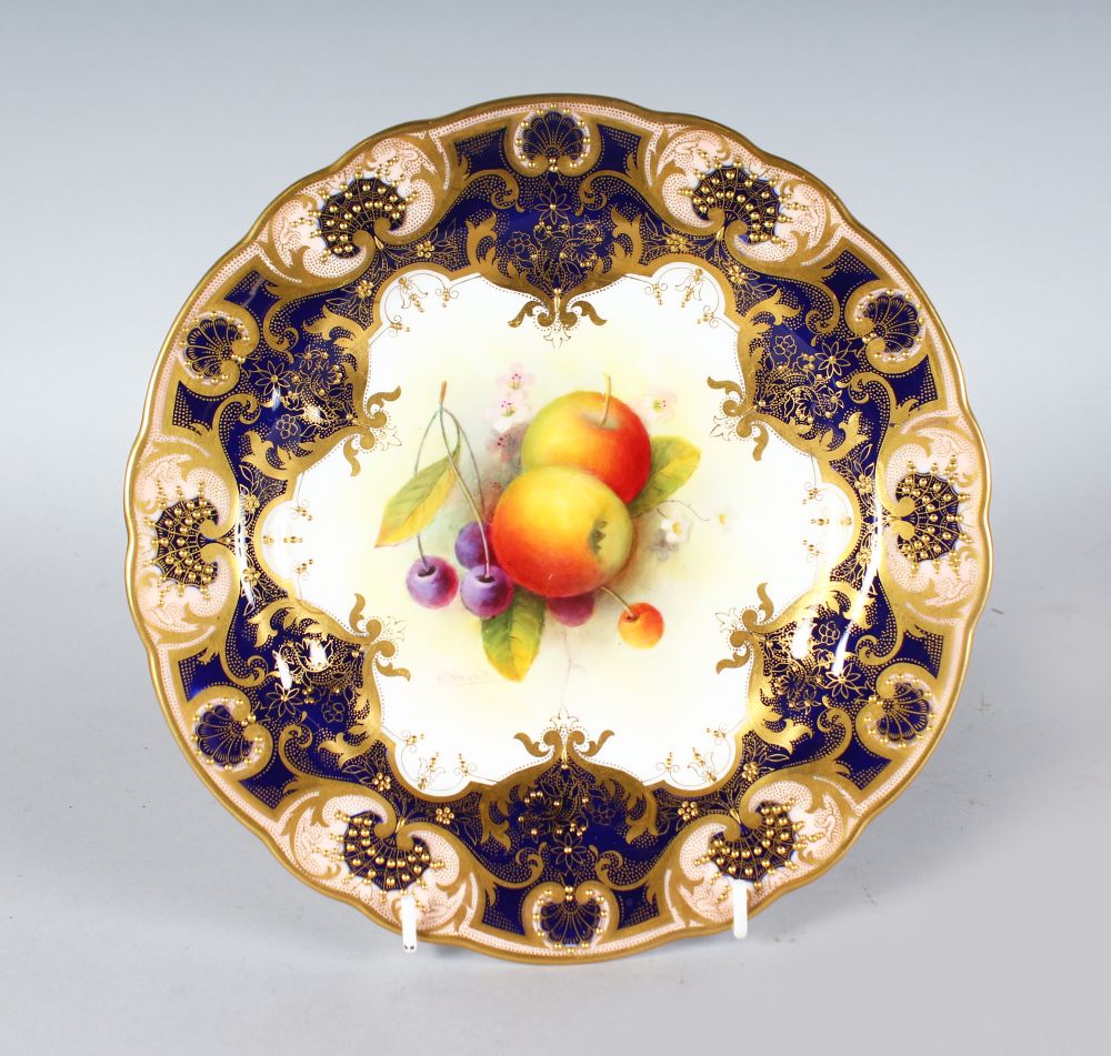 A ROYAL WORCESTER GOOD PLATE painted fruit under a heavily gilt and cobalt blue border by A.