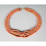 A VERY GOOD FOUR ROW CORAL NECKLACE with gold clasp.