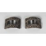 A PAIR OF CHINESE SILVER BUCKLES.