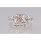 AN 18CT VERY IMPRESSIVE DIAMOND RING of 4.4CTS, the central Princess diamond of 3cts with