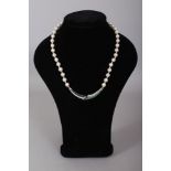 A VERY GOOD CULTURED PEARL NECKLACE with sapphire, emerald and diamond bar.