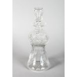A CUT THISTLE SHAPED DECANTER AND STOPPER.