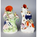 TWO STAFFORDSHIRE SPILL VASES, young Scottish girl with swan and Scottish boy with a dog (2). 7ins
