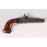 A 19TH CENTURY PERCUSSION CAP PISTOL with engraved octagonal barrel and carved stock. 7ins long.