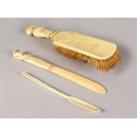 A CARVED IVORY BACK BRUSH, paddle and paperknife (3).