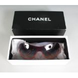 A PAIR OF CHANEL SUNGLASSES, in a Chanel box.