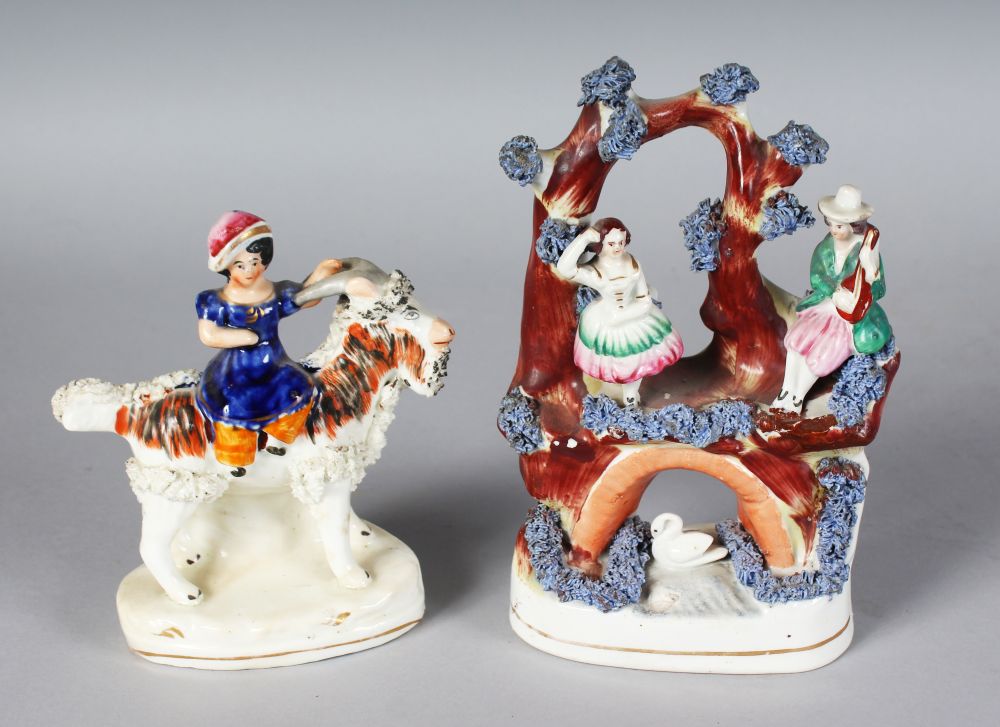 A STAFFORDSHIRE FIGURE OF A GIRL riding an encrusted goat, 5ins high, and AN ENCRUSTED ARCH with