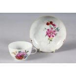 A CONTINENTAL CUP AND SAUCER painted with flowers. Mark AP.