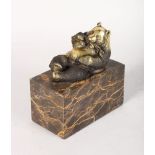 MILO A BRONZE BEAR. Signed. 4ins long, on a marble plinth.