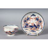 AN 18TH CENTURY. WORCESTER RARE TEA BOWL AND SAUCER painted in under-glaze blue and over-glaze red