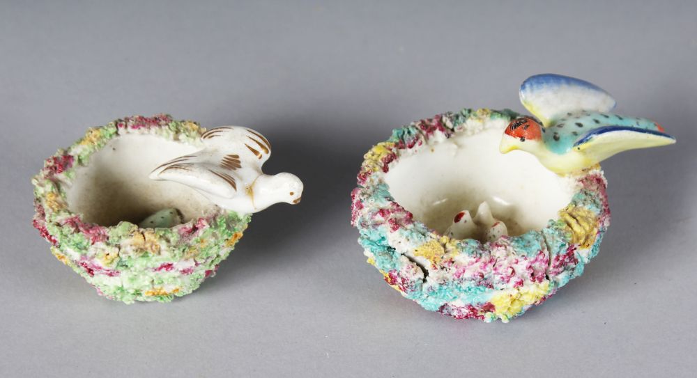 TWO SMALL STAFFORDSHIRE ENCRUSTED BIRD NESTS with bird and eggs.