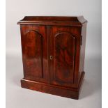 A 19TH CENTURY WALNUT SPECIMEN CABINET with double panel doors, opening to reveal three drawers.