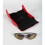 A PAIR OF CARTIER WHITE METAL PANTHER SUNGLASSES, in a red Cartier case.