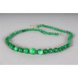 A GOOD STRING OF SIXTY-TWO GREEN JADE BEADS.